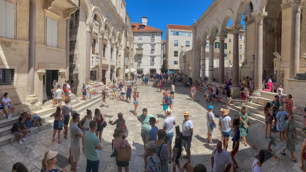 Split, Croatia, 8-6-2021: Tourists crowd the square in front of Diocletian's palace.