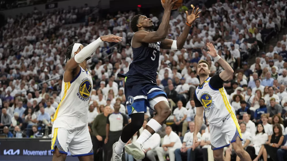 Minnesota Timberwolves guard Anthony Edwards (5) looks to shoot against Golden State Warriors' Pat Spencer, right, and Buddy Hield, left, during the second half of Game 5 of an NBA basketball second-round playoff series, Wednesday, May 14, 2025, in Minneapolis. (AP Photo/Abbie Parr)