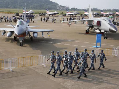﻿Chinese Air Force personnel march past the Chinese military's J10C fighter and JH-7A2 fighter bomber during 13th China International Aviation and Aerospace Exhibition, also known as Airshow China 2021, Wednesday, Sept. 29, 2021, in Zhuhai in southern China's Guangdong province. With record numbers of military flights near Taiwan over the last week, China has been stepping up its harassment of the island it claims as its own, showing an new intensity and sophistication as it asserts its territorial claims in the region. (AP Photo/Ng Han Guan)