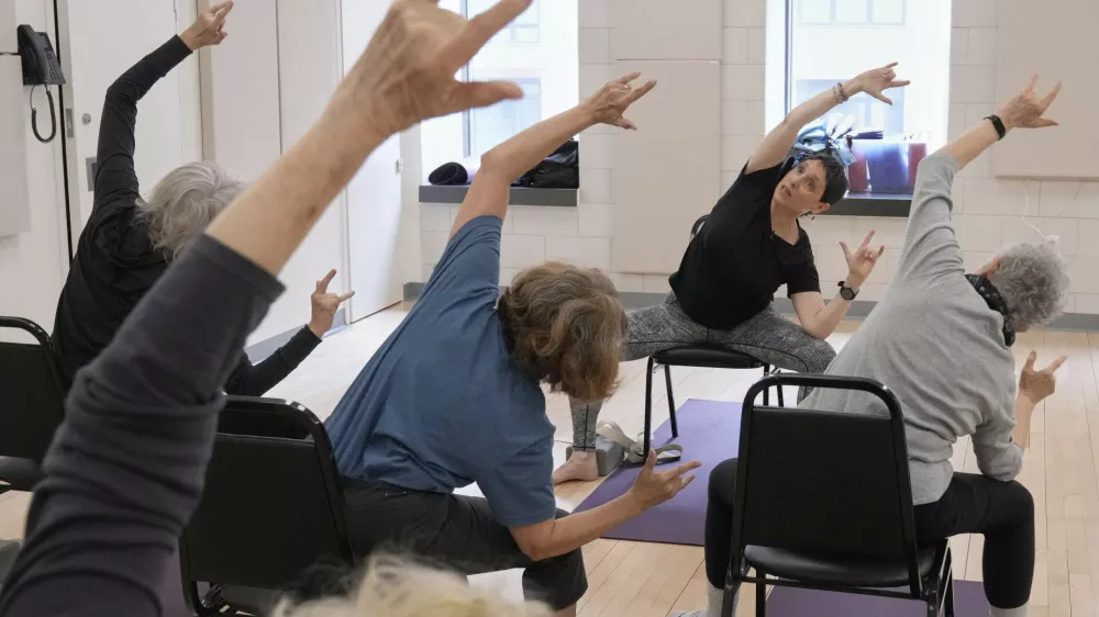Whitney Chapman, right, conducts a chair yoga class at the Marlene Meyerson JCC Manhattan, in New York, March 28, 2025. (AP Photo/Richard Drew)