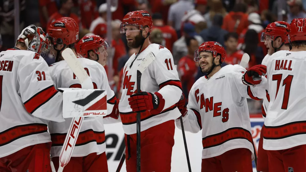 May 15, 2025; Washington, District of Columbia, USA; Carolina Hurricanes players celebrate after their series clinching win against the Washington Capitals in game five of the second round of the 2025 Stanley Cup Playoffs at Capital One Arena. Mandatory Credit: Geoff Burke-Imagn Images