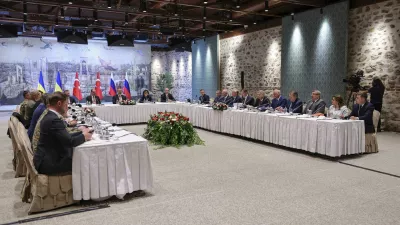 In this handout photo released by Turkish Foreign Ministry, Turkish Foreign Minister Hakan Fidan, center, chairs a meeting between delegations from Russia, right, and Ukraine, left, at Dolmabahce palace in Istanbul, Turkey, Friday, May 16, 2025. (Murat Gok/Turkish Foreign Ministry via AP)