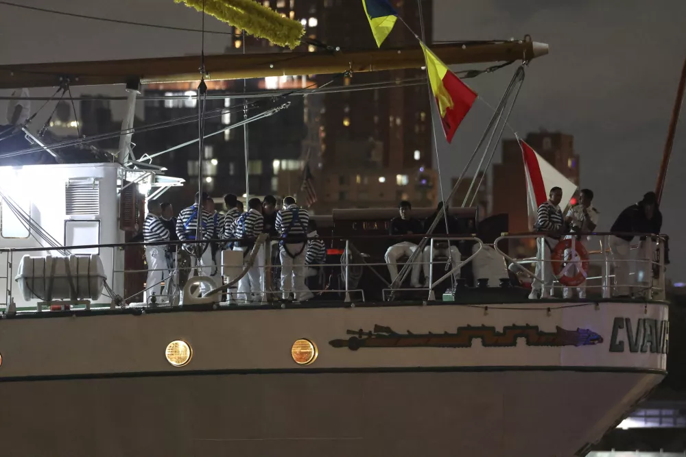Crew members aboard the Cuauhtémoc, a masted Mexican Navy training ship, gather on deck after the ship collided with the Brooklyn Bridge, Saturday, May 17, 2025, in New York. (AP Photo/Yuki Iwamura)