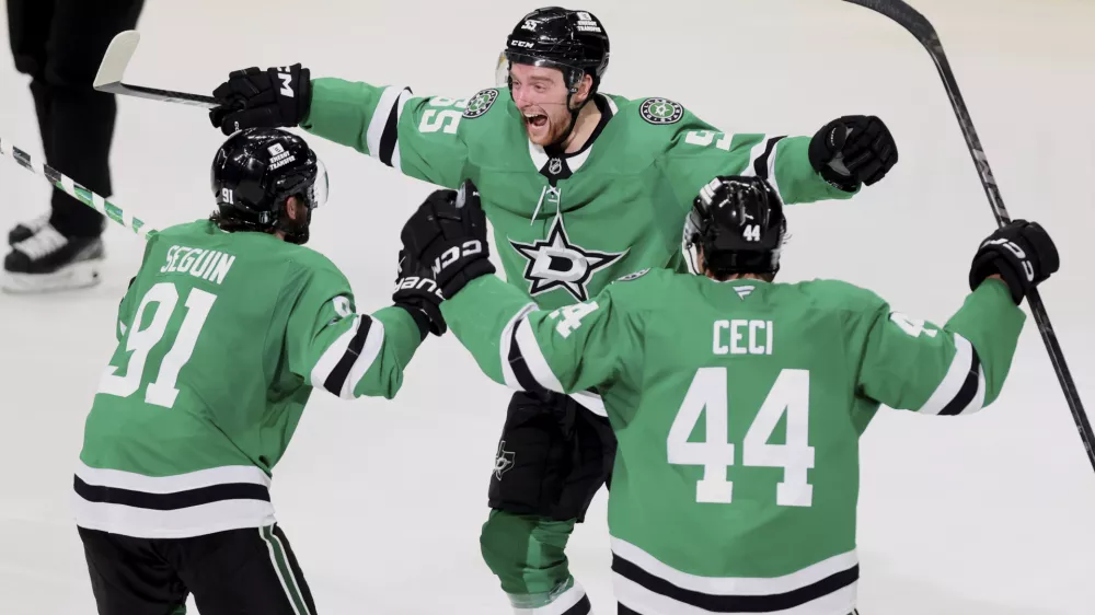 Dallas Stars' Tyler Seguin (91), Thomas Harley (55) and Cody Ceci (44) celebrate after Harley scored in overtime in Game 6 of a second-round NHL hockey playoff series against the Winnipeg Jets in Dallas, Saturday, May 17, 2025. (AP Photo/Gareth Patterson)