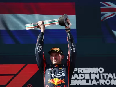 Formula One F1 - Emilia Romagna Grand Prix - Autodromo Enzo e Dino Ferrari, Imola, Italy - May 18, 2025 Red Bull's Max Verstappen celebrates on the podium with a trophy after winning the Emilia Romagna Grand Prix REUTERS/Jakub Porzycki