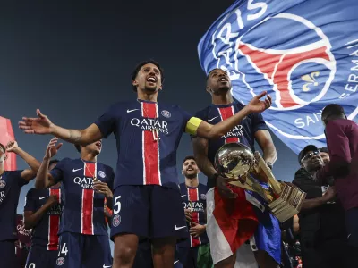 Paris Saint Germain players celebrate PSG's French League One title after the League One soccer match between Paris Saint-Germain and Auxerre at the Parc des Princes stadium in Paris, Saturday, May 17, 2025. (Franck Fife/Pool via AP)