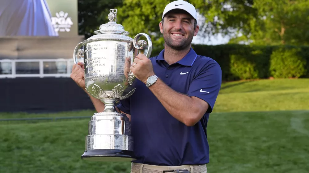 May 18, 2025; Charlotte, North Carolina, USA; Scottie Scheffler poses for a photo with the Wanamaker Trophy after winning the PGA Championship golf tournament at Quail Hollow. Mandatory Credit: Jim Dedmon-Imagn Images