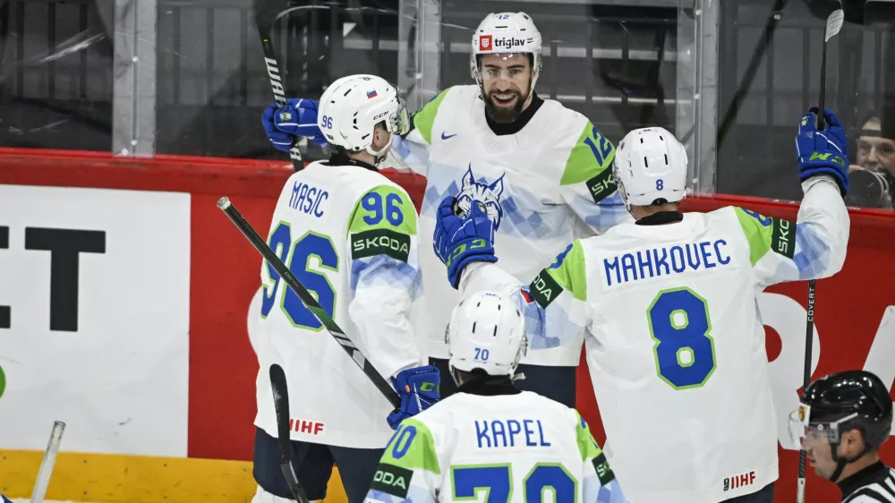 Slovenia's Nik Simsic, rear center, celebrates scoring with teammates during the IIHF Ice Hockey World Championship group A match between France and Slovenia in Stockholm, Sweden, Monday, May 19, 2025. (Fredrik Sandberg/TT News Agency via AP)