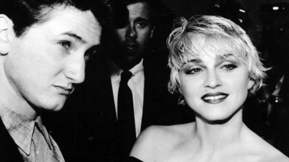 Sean Penn and his wife, singer Madonna, stop April 17, 1986 to chat with reporters prior to the screening of Penn's new movie "At Close Range" in Los Angeles. (AP photo/Craig Mathew)