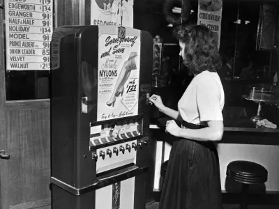 Photo taken on December 1948 of a young woman buying nylon stockings on an automatic vending machine of the brand "DuPont" installed in a restaurant of New York, United States.,Image: 472032919, License: Rights-managed, Restrictions:, Model Release: no