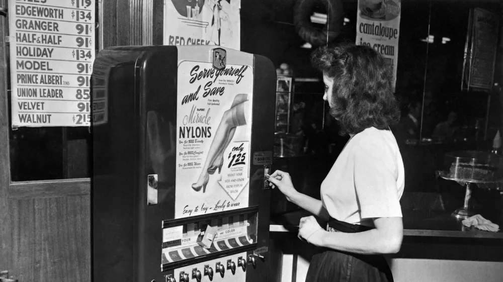 Photo taken on December 1948 of a young woman buying nylon stockings on an automatic vending machine of the brand "DuPont" installed in a restaurant of New York, United States.,Image: 472032919, License: Rights-managed, Restrictions:, Model Release: no