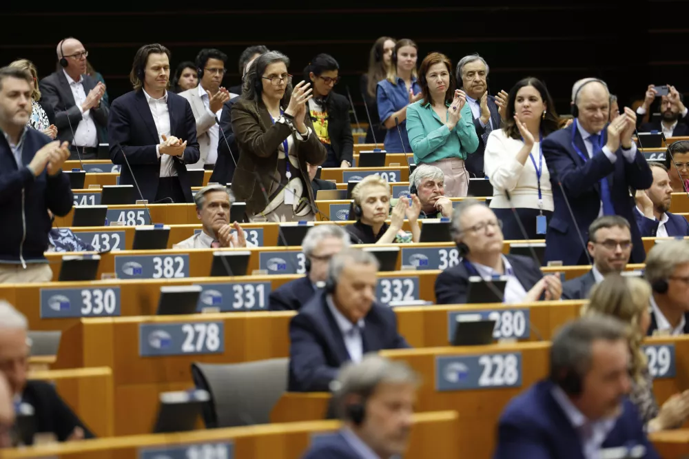 Members of European Parliament applaud after a speech by Slovenia's President Natasa Pirc Musar during a plenary session at the European Parliament building in Brussels, Wednesday, May 21, 2025. (AP Photo/Geert Vanden Wijngaert)