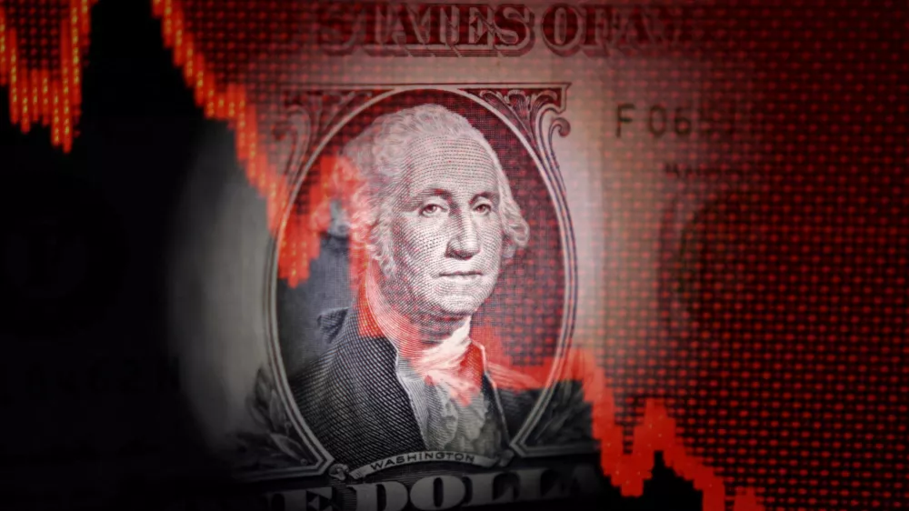 FILE PHOTO: U.S. dollar banknote and decreasing stock graph are seen in this illustration taken April 25, 2025. REUTERS/Dado Ruvic/Illustration/File Photo