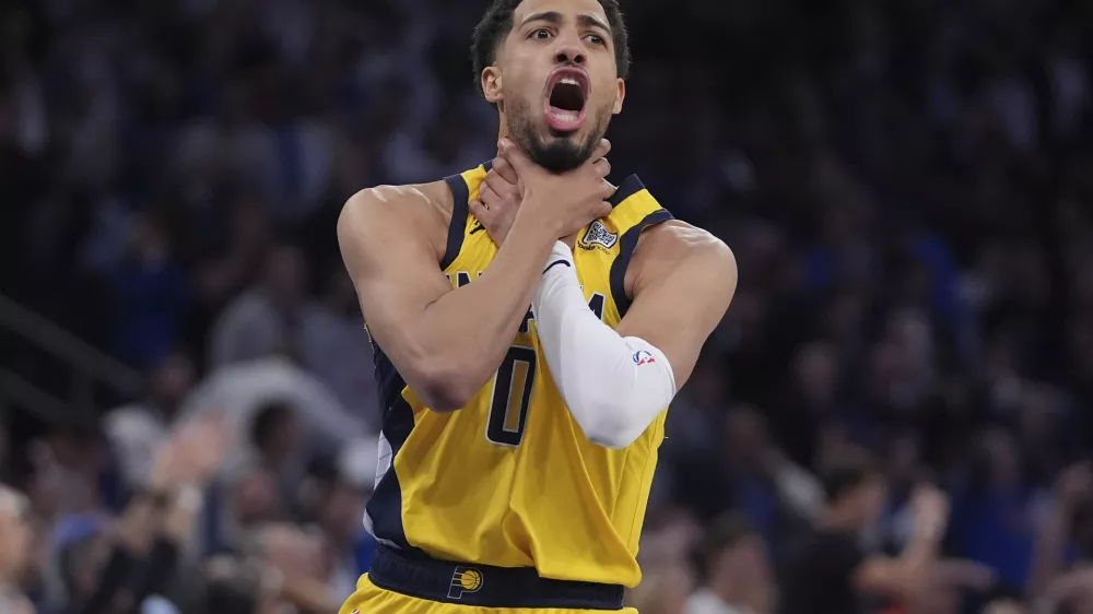 Indiana Pacers guard Tyrese Haliburton (0) makes a choke motion towards the New York Knicks after hitting a shot at the end of the fourth quarter of Game 1 of the NBA basketball Eastern Conference final, Wednesday, May 21, 2025, in New York. (AP Photo/Frank Franklin II)
