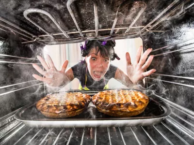 Funny Housewife overlooked cakes in the oven, so she had scorched, view from the inside of the oven. Housewife perplexed and angry. Loser is destiny!