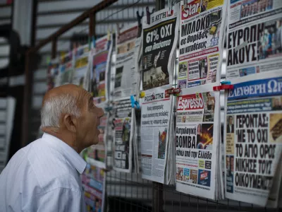 ﻿A man looks at the newspapers at a newsstand in central Athens, Monday, July 6, 2015. Greece's finance minister has resigned following Sunday's referendum in which the majority of voters said "no" to more austerity measures in exchange for another financial bailout. (AP Photo/Emilio Morenatti)