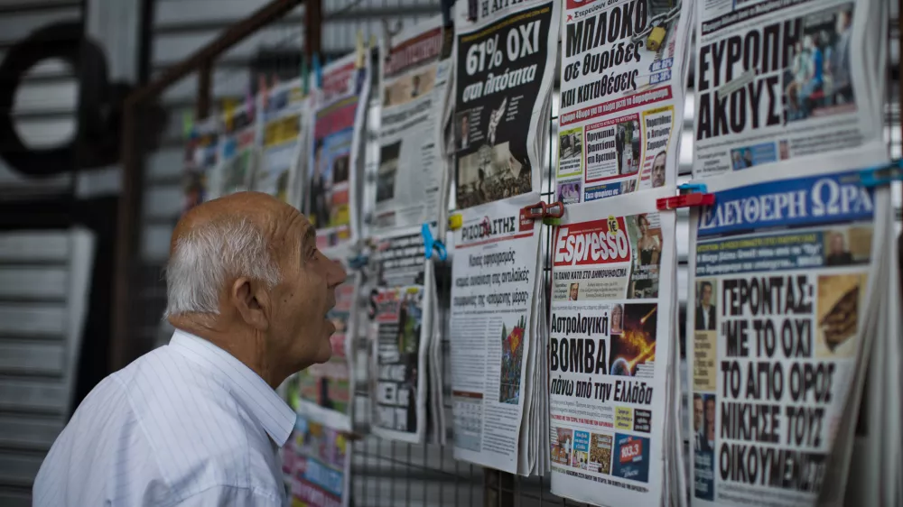 ﻿A man looks at the newspapers at a newsstand in central Athens, Monday, July 6, 2015. Greece's finance minister has resigned following Sunday's referendum in which the majority of voters said "no" to more austerity measures in exchange for another financial bailout. (AP Photo/Emilio Morenatti)