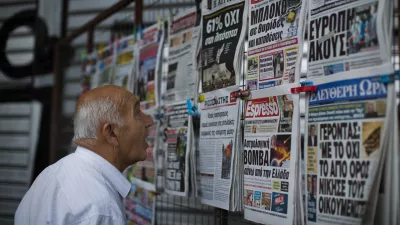 ﻿A man looks at the newspapers at a newsstand in central Athens, Monday, July 6, 2015. Greece's finance minister has resigned following Sunday's referendum in which the majority of voters said "no" to more austerity measures in exchange for another financial bailout. (AP Photo/Emilio Morenatti)