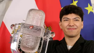 FILE PHOTO: JJ, representing Austria, winner of the 2025 Eurovision Song Contest, holds his trophy during a visit to the Chancellery in Vienna, Austria, May 19, 2025. REUTERS/Leonhard Foeger/File Photo