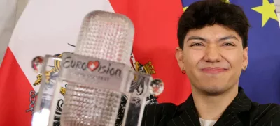 FILE PHOTO: JJ, representing Austria, winner of the 2025 Eurovision Song Contest, holds his trophy during a visit to the Chancellery in Vienna, Austria, May 19, 2025. REUTERS/Leonhard Foeger/File Photo