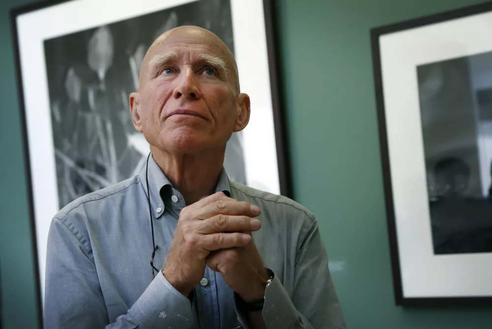 FILE - Brazilian photographer Sebastião Salgado leads a tour of his exhibition, "Sebastião Salgado: Genesis," on April 24, 2014, at the National Museum of Singapore. (AP Photo/Wong Maye-E, File)