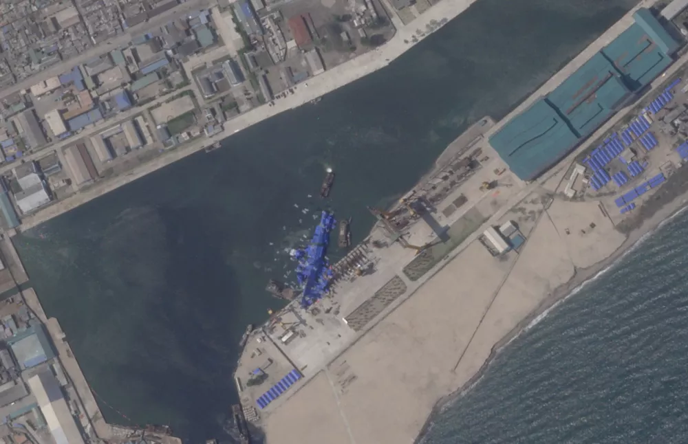 A satellite image shows a North Korean warship covered with a blue tarp after an accident that occurred during its launch at the shipyard in Chongjin, North Korea, May 24, 2025. 2025 Planet Labs PBC/Handout via REUTERS THIS IMAGE HAS BEEN SUPPLIED BY A THIRD PARTY. MANDATORY CREDIT.