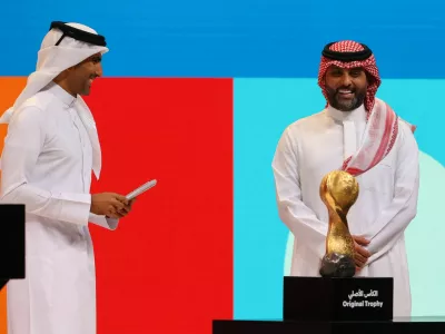 Soccer Football - FIFA U-17 World Cup and FIFA Arab Cup Qatar 2025 Finals Draw in Doha - Fairmont Hotel, Doha, Qatar - May 25, 2025 Host Mohammed Saadoun Al Kuwari with former Saudi Arabian footballer Yasser Al-Qahtani during the draw REUTERS/Ibraheem Al Omari
