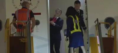 In this grab taken from video, France's President Emmanuel Macron prepares to disembark a plane on arrival, in Hanoi, Vietnam, Sunday, May 25, 2025. (AP Photo/Hau Dinh)