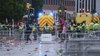 Police and emergency personnel deal with an incident near the Liver Building during the Premier League winners parade in Liverpool, England, Monday, May 26, 2025.(AP Photo/Jon Super)