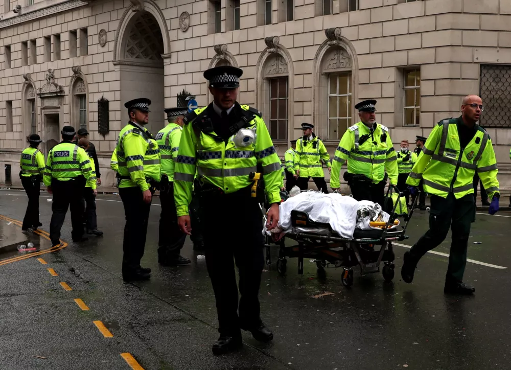 Soccer Football - Premier League - Liverpool Victory Parade - Liverpool, Britain - May 26, 2025 A person is taken away on a stretcher after multiple people were hit by a car during the Victory parade Action Images via Reuters/Lee Smith