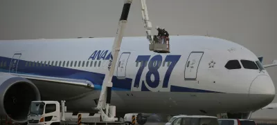 Mechanics of All Nippon Airways (ANA) work beside the company's Boeing Co's 787 Dreamliner plane at Haneda airport in Tokyo January 16, 2013. All Nippon Airways Co Ltd said on Wednesday it will put its Boeing Co 787 Dreamliners back in operation once checks were completed on the aircraft, as soon as Thursday. The suspension of 17 of its Dreamliner aircraft came after one of the jets made an emergency landing in western Japan earlier in the day. REUTERS/Toru Hanai (JAPAN - Tags: TRANSPORT BUSINESS)