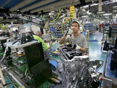 ﻿In this Aug. 2, 2017, photo, Nissan Motor Co. factory workers check engines on an assembly line at its plant in Yokohama, near Tokyo. Aiming to get an edge on its rivals in an intensely competitive industry, Japanese automaker Nissan says itâ€™s attempting to foster a corporate culture that will produce manufacturing innovations in leaps and bounds instead of steady incremental improvement. Its discussion of that effort is partly a swipe at bigger competitor Toyota Motor Corp. which for decades has favored the concept of â€śkaizenâ€ť or fine tuning and bit-by-bit progress in auto manufacturing. (AP Photo/Shizuo Kambayashi)