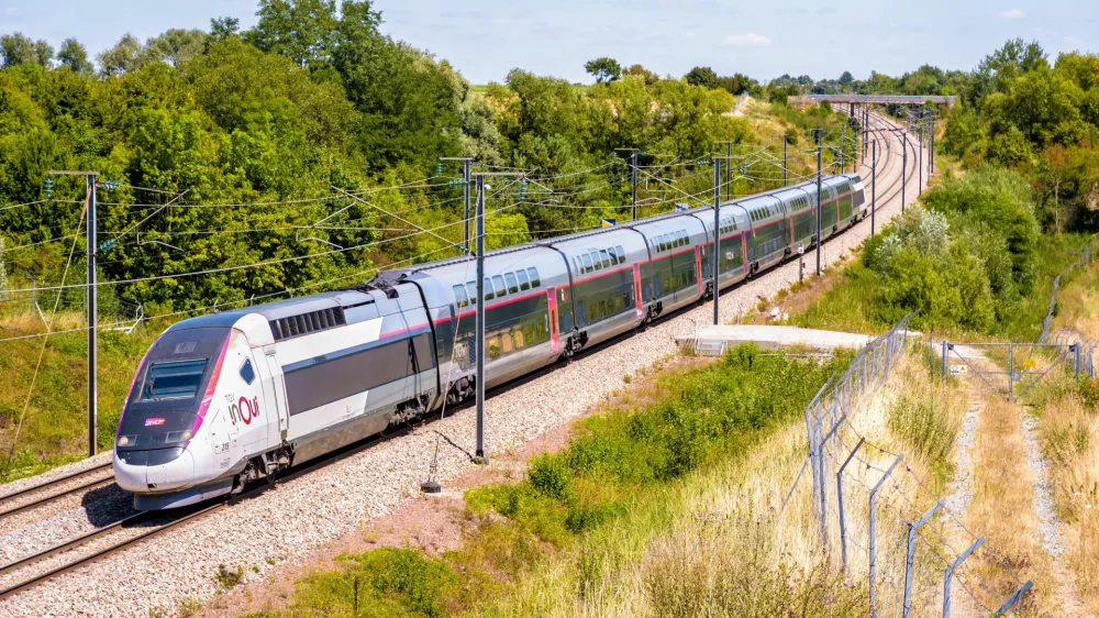 ﻿Ver-sur-Launette, France - July 29, 2020: A TGV Duplex inOui high speed train from french rail company SNCF is driving from Lille to Paris on the LGV Nord, the North European high speed railway line.