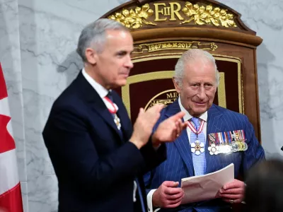 Prime Minister of Canada Mark Carney applauds as King Charles III delivers his speech from the Throne, in the Senate Chamber at the Senate of Canada Building for the State Opening of the Parliament of Canada, as part of the Royals' two-day visit to Canada, in Ottawa May 27, 2025.  Victoria Jones/Pool via REUTERS