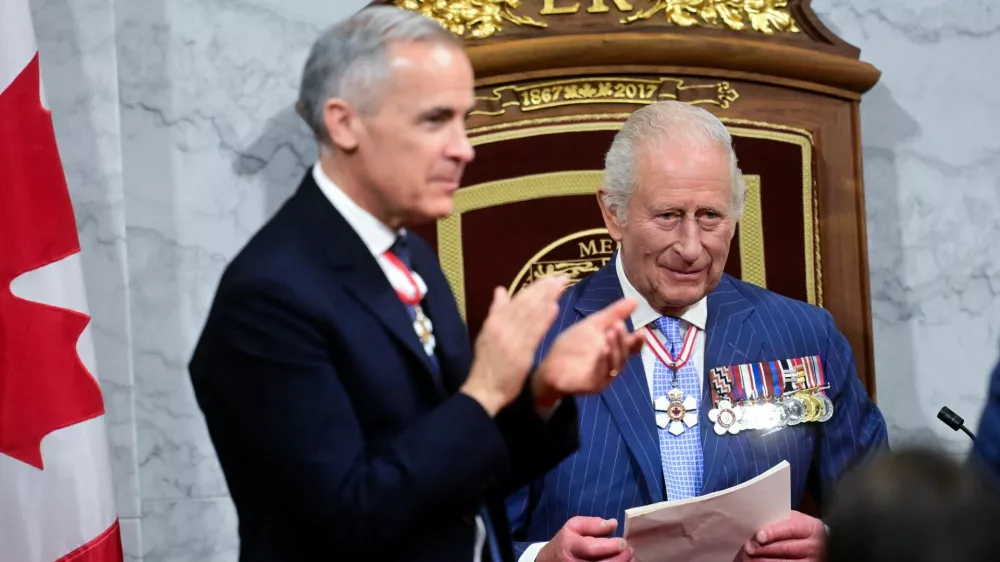 Prime Minister of Canada Mark Carney applauds as King Charles III delivers his speech from the Throne, in the Senate Chamber at the Senate of Canada Building for the State Opening of the Parliament of Canada, as part of the Royals' two-day visit to Canada, in Ottawa May 27, 2025.  Victoria Jones/Pool via REUTERS