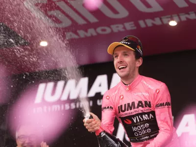 30 May 2025, Italy, Sestriere: British cyclist Simon Yates of Team Visma | Lease A Bike celebrates with pink jersey on the podium after the Twentieth stage of the 108th Giro d'Italia cycling race, 205km from Verres to Sestriere. Photo: Massimo Paolone/LaPresse via ZUMA Press/dpa