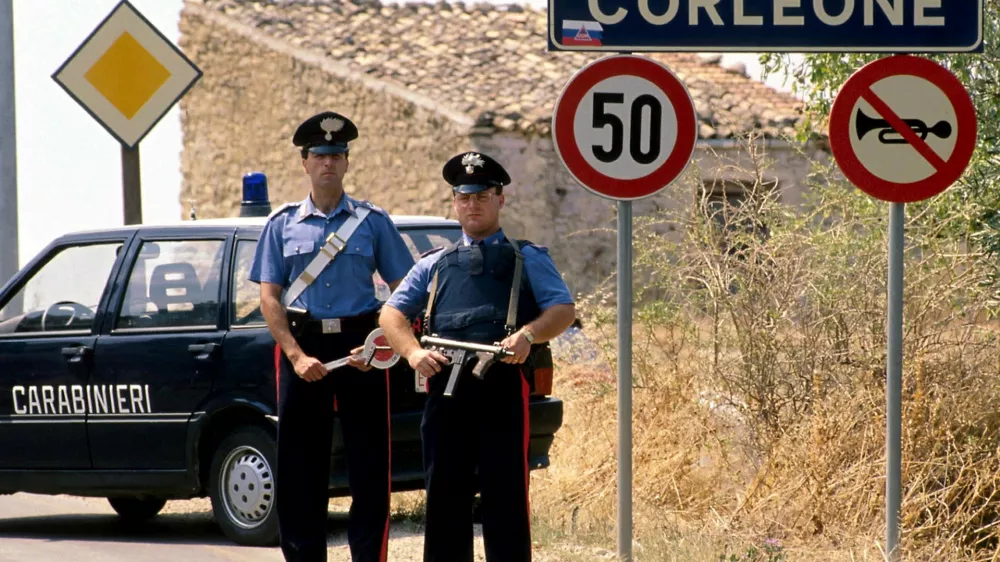 Italian carabinieri (military police) stand guard outside the small Sicilian town of Corleone in this 1992 file photo. Bernardo Provenzano, the undisputed chief of the Sicilian Mafia who had been on the run for more than four decades, was arrested while hiding in a farmhouse near Corleone in Sicily on April 11, 2006 officials said. Provenzano, known as the "Phantom of Corleone" after his native hill town, made famous by the Godfather films, has been running the Mafia since former "boss of bosses" Toto Riina was arrested in 1993. REUTERS/Tony Gentile