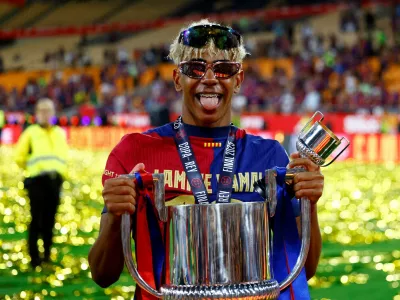 FILE PHOTO: Soccer Football - Copa del Rey - Final - FC Barcelona v Real Madrid - Estadio de La Cartuja, Seville, Spain - April 26, 2025 FC Barcelona's Lamine Yamal celebrates with the trophy after winning the Copa del Rey REUTERS/Borja Suarez/File Photo