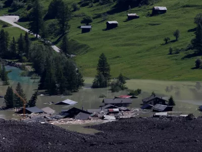 A few remaining houses are seen after a massive rock and ice slide covered most of the village of Blatten, Switzerland May 29, 2025. REUTERS/Stefan Wermuth