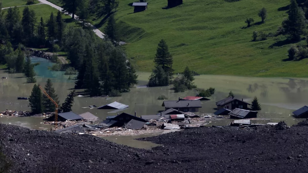 A few remaining houses are seen after a massive rock and ice slide covered most of the village of Blatten, Switzerland May 29, 2025. REUTERS/Stefan Wermuth