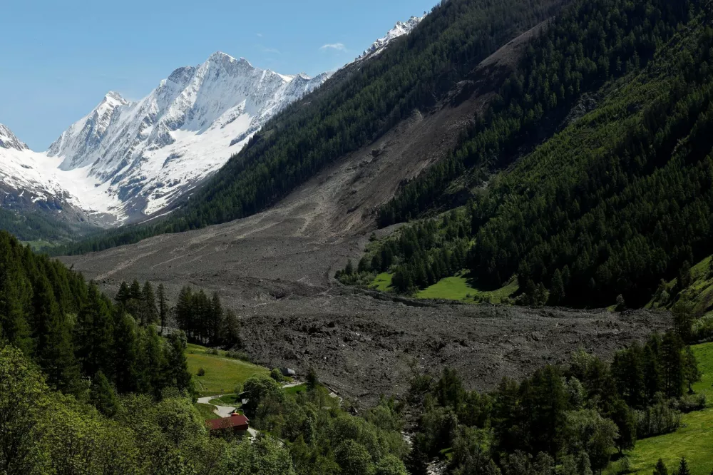 Debris and dust from a crumbling glacier that partially collapsed and tumbled onto the village of Blatten, Switzerland is seen on May 29, 2025. REUTERS/Stefan Wermuth
