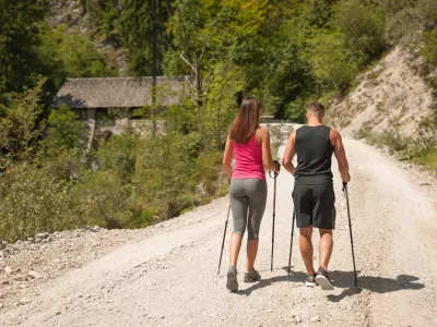 Active young couple on a hike in forest on a hot wummer day