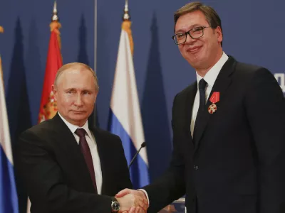 FILE - Russian President Vladimir Putin, left, shakes hands with Serbian President Aleksandar Vucic after being awarded the Order of Alexander Nevsky in Belgrade, Serbia, Thursday, Jan. 17, 2019. (AP Photo/Darko Vojinovic, File)