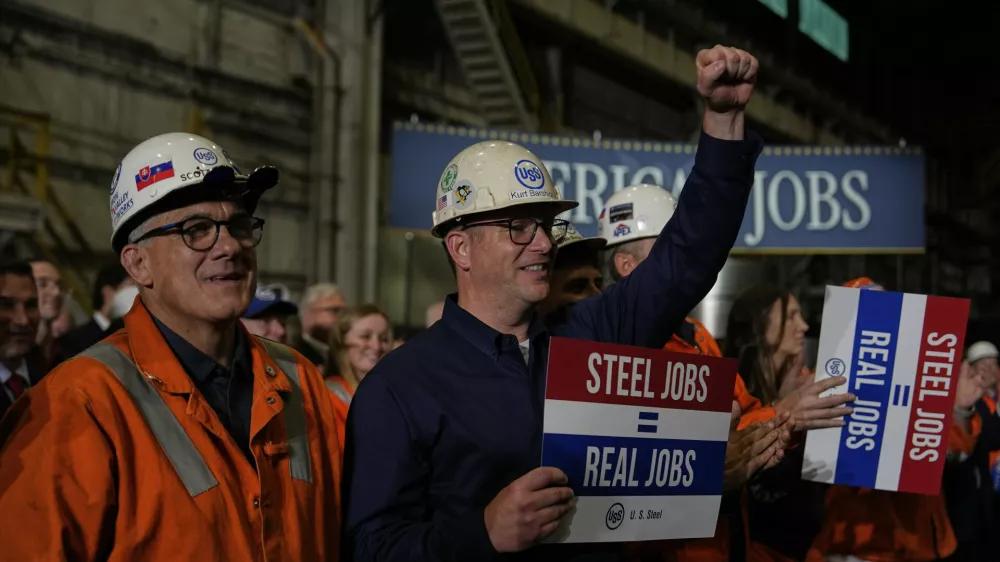 People listen as President Donald Trump speaks at U.S. Steel Corporation's Mon Valley Works-Irvin plant, Friday, May 30, 2025, in West Mifflin, Pa. (AP Photo/Julia Demaree Nikhinson)