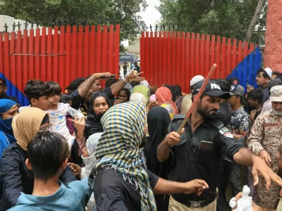 A police officer with a baton reacts as he disperses the family members of the prisoners, after dozens of prisoners escaped from the district Malir Jail, on the outskirts of Karachi, Pakistan, June 3, 2025. REUTERS/Akhtar Soomro