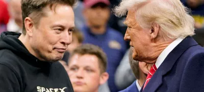FILE PHOTO: Elon Musk greets U.S. President Donald Trump as they attend the NCAA men's wrestling championships in Philadelphia, Pennsylvania, U.S., March 22, 2025. REUTERS/Nathan Howard/File Photo