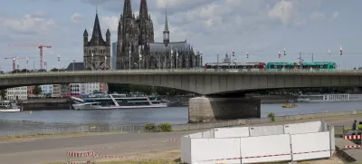 One of the three unexploded bombs from the Second World War is fenced off with screens as specialists prepare to defuse them in Cologne, Tuesday, June 3, 2025. (Thomas Banneyer/dpa via AP)