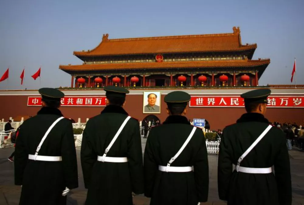 ﻿Paramilitary policemen stand guard in front of the giant portrait of former Chinese Chairman Mao Zedong at Beijing's Tiananmen Square November 15, 2012. China's ruling Communist Party unveiled its new leadership line-up on Thursday to steer the world's second-largest economy for the next five years, with Vice President Xi Jinping taking over from outgoing President Hu Jintao as party chief. REUTERS/David Gray (CHINA - Tags: POLITICS CRIME LAW MILITARY)