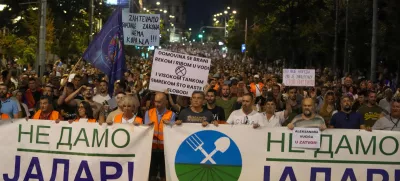 People hold banners reading, "We Won't Give up Jadar!" and march during a protest against pollution and the exploitation of a lithium mine in the country in Belgrade, Serbia, Saturday, Aug. 10, 2024. Jadar is a farming valley in western Serbia that holds one of Europe's richest deposits of lithium. (AP Photo/Darko Vojinovic)