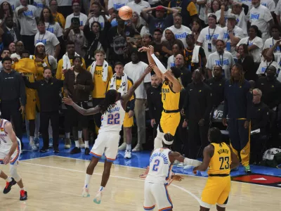 Indiana Pacers guard Tyrese Haliburton (0) shoots a 3-pointer against Oklahoma City Thunder guard Cason Wallace (22) during the second half of Game 1 of the NBA Finals basketball series Thursday, June 5, 2025, in Oklahoma City. (AP Photo/Nate Billings)